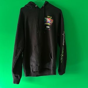 Black hoodie with multi-colored graphics on front left chest, back, and sleeves